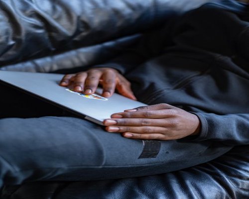 A person wrapping up their work on a laptop preparing for rest