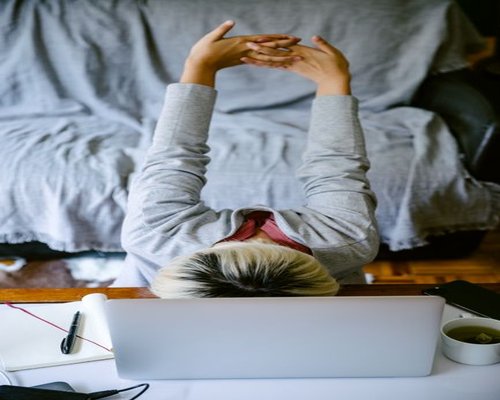 A professional taking a brief mindful break from typing